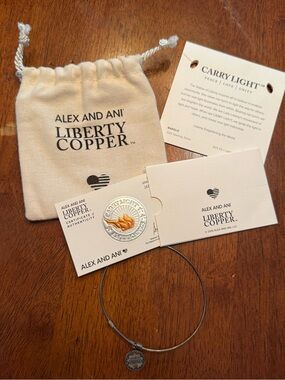 This item is the Alex and Ani Liberty Copper "Carry Light" Expandable Bangle.